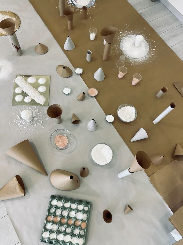 Studio table with paper cones, salt, and natural materials
