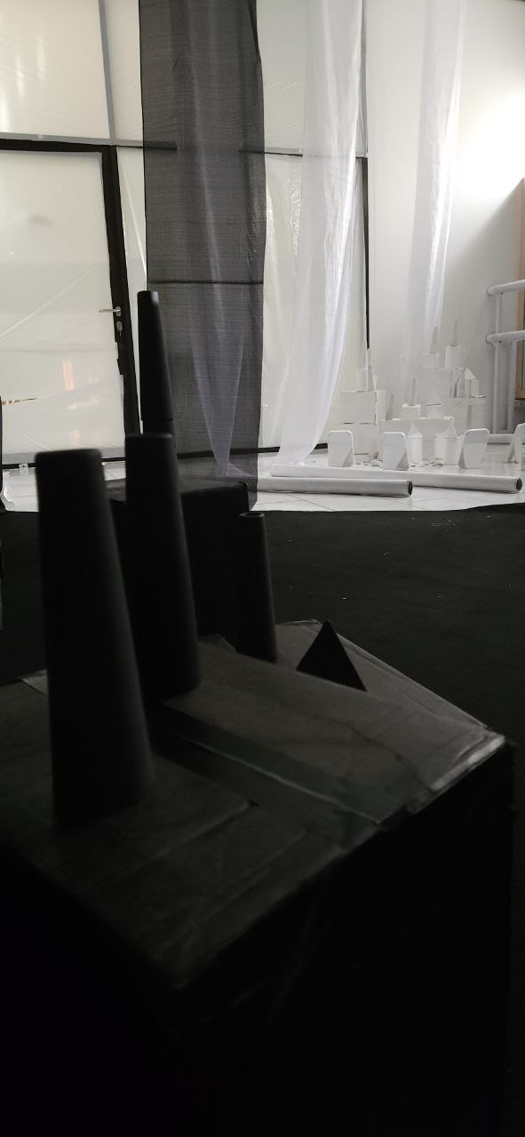 Dark sculptural cityscape with sheer curtains