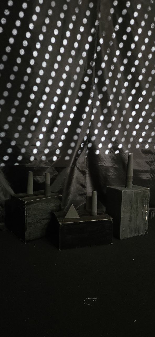 Polka-dot light pattern projected over sculptural blocks