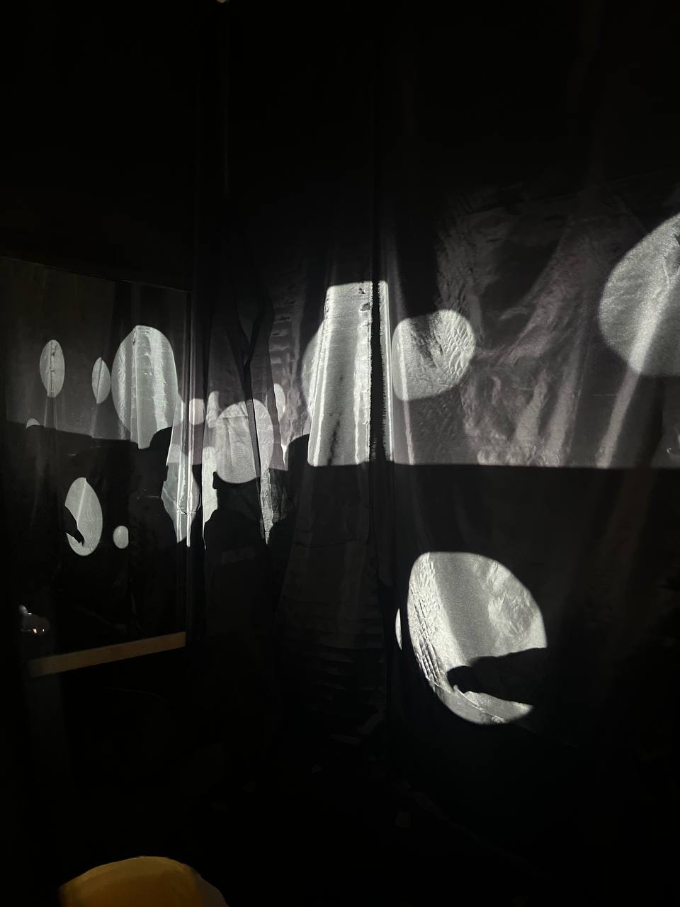 Circular light projections on draped fabric